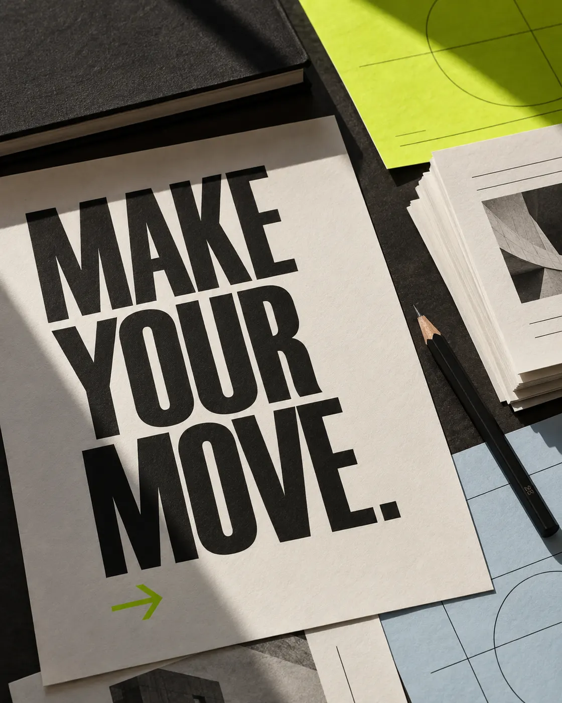 Bold typography and content sheets arranged with lime-coloured paper.